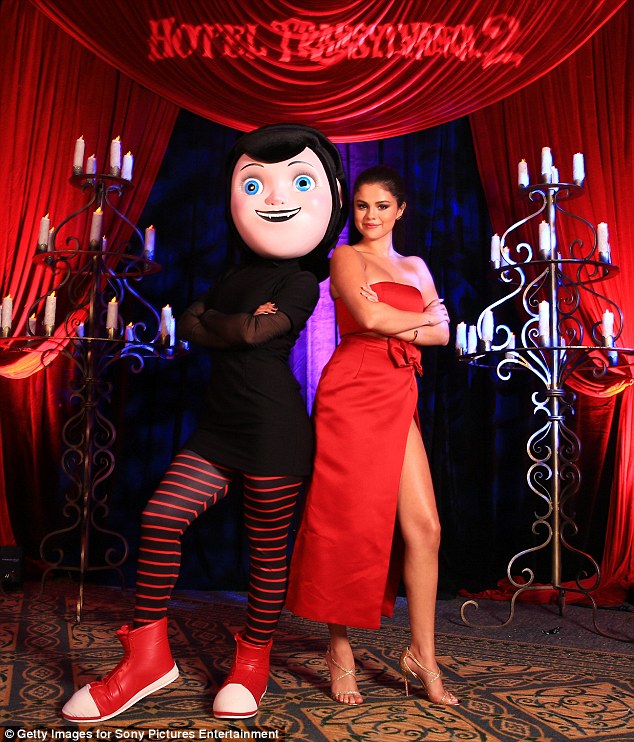 Selena Gomez puts on a leggy display in a shiny rose-coloured dress with VERY high split at Hotel Transylvania 2 photo call